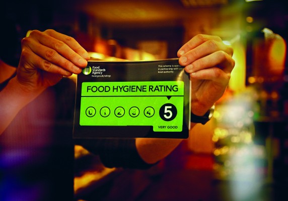 A 5-rated Food Hygiene Rating sign is stuck to a restaurant window.