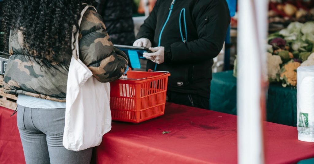 This photo shows a transaction between staff and customer at a food stall.