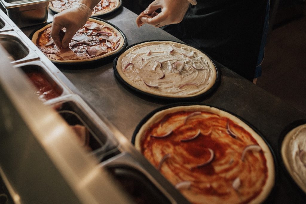 A food handler safely prepares pizza. What can an environmental health officer do if she doesn't?