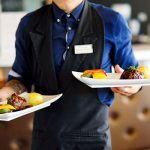 12 man holding two plates dinners