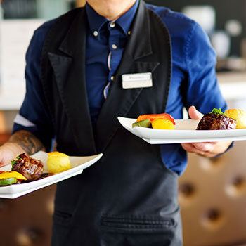 man holding two plates dinners