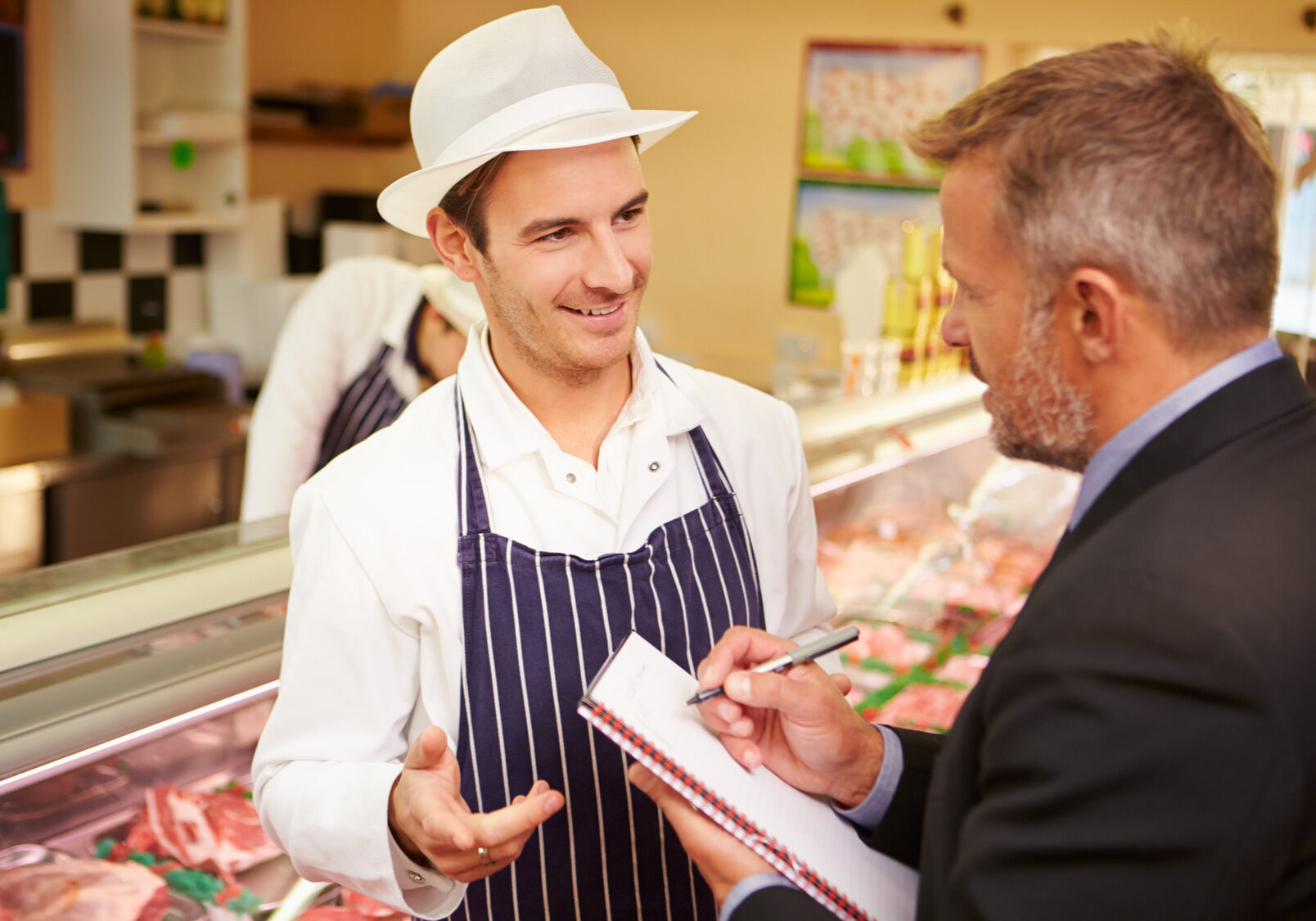 Bank Manager Meeting With Owner Of Butchers Shop